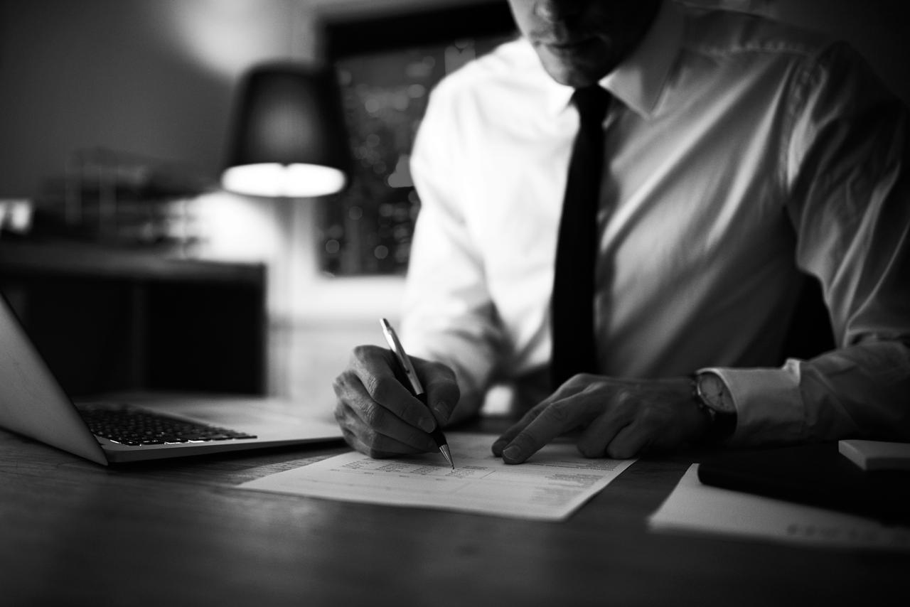 Businessman signing contract at office