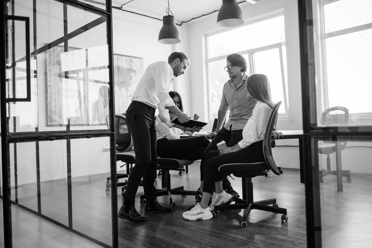 Four people are having an informal meeting in the office