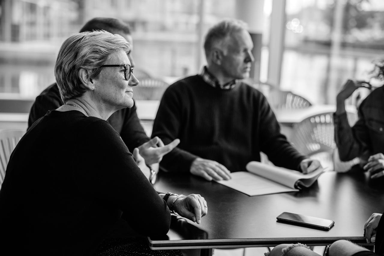 Senior businesswoman sitting in boardroom meeting.