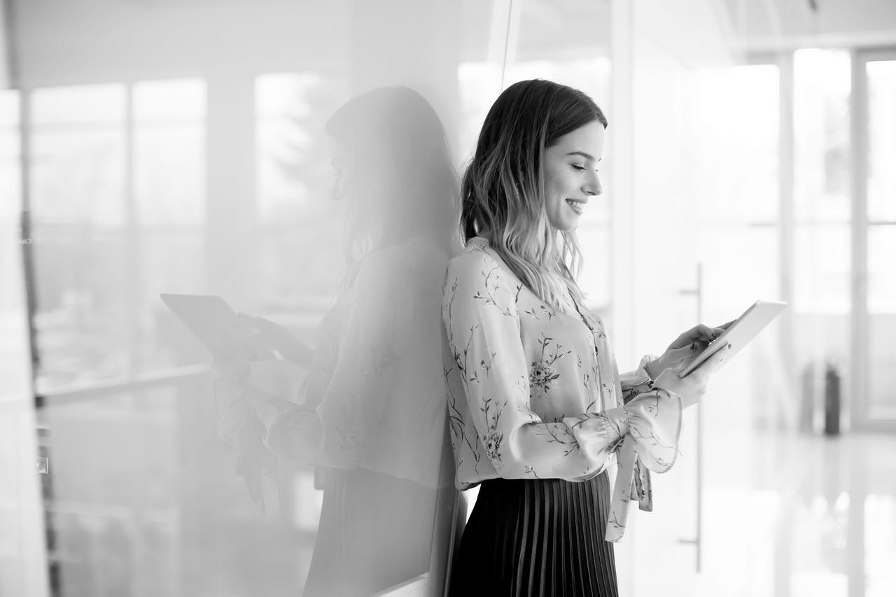 Young businesswoman with tablet in modern office