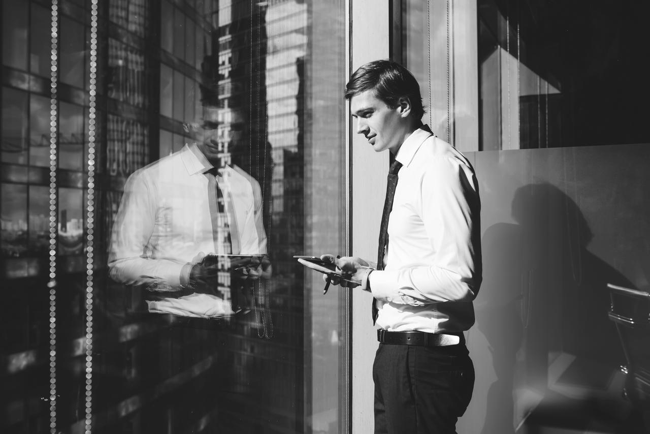 young-man-looking-out-office-tower.jpg